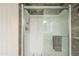 Shower with glass doors and gray tile accent wall at 10177 E La Palma Ave, Gold Canyon, AZ 85118