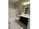 Bright bathroom with white tile, modern vanity, and shower over tub for convenience and comfort at 10736 W Swayback Pass, Peoria, AZ 85383