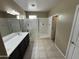 Stylish bathroom with a glass-enclosed shower, double sink vanity, and well-lit mirror at 10736 W Swayback Pass, Peoria, AZ 85383