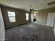 Spacious bedroom with large windows offering natural light, plush carpeting, and ceiling fan at 10736 W Swayback Pass, Peoria, AZ 85383