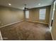 Cozy bedroom with neutral tones, plush carpet, and ample natural light filtering through the windows at 10736 W Swayback Pass, Peoria, AZ 85383