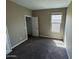Comfortable carpeted bedroom with a large window and a closet door at 10736 W Swayback Pass, Peoria, AZ 85383