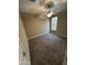 This cozy bedroom features soft carpet, a ceiling fan, and a bright window at 10736 W Swayback Pass, Peoria, AZ 85383