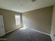 This cozy bedroom features soft carpet and a bright window at 10736 W Swayback Pass, Peoria, AZ 85383