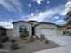 Charming single-story home with a three car garage, desert landscaping, and a neutral color palette at 10736 W Swayback Pass, Peoria, AZ 85383