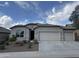 Charming single-story home with a three car garage, desert landscaping, and a neutral color palette at 10736 W Swayback Pass, Peoria, AZ 85383
