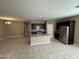 Open floor plan: kitchen features an island, stainless steel appliances, and tile flooring at 10736 W Swayback Pass, Peoria, AZ 85383