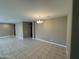 Spacious living room featuring tile flooring and a modern light fixture at 10736 W Swayback Pass, Peoria, AZ 85383