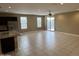 Spacious living room features tile flooring, neutral walls, and a sliding glass door to the backyard at 10736 W Swayback Pass, Peoria, AZ 85383