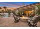 Inviting backyard featuring a pool, covered patio, and a cozy fire pit surrounded by comfortable seating at 10907 E Bella Vista Dr, Scottsdale, AZ 85259