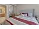 Comfortable bedroom featuring a plush bed with a tufted headboard and ensuite bathroom access at 10907 E Bella Vista Dr, Scottsdale, AZ 85259