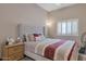 Inviting bedroom featuring a comfortable bed, a nightstand, and a large window with plantation shutters at 10907 E Bella Vista Dr, Scottsdale, AZ 85259