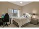Cozy bedroom featuring a ceiling fan, carpet, and a sunny window at 10907 E Bella Vista Dr, Scottsdale, AZ 85259