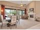 Spacious dining room with large windows, a fireplace, and access to the outdoor patio at 10907 E Bella Vista Dr, Scottsdale, AZ 85259