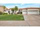 Charming home with a well-manicured lawn and a three-car garage with a tile roof at 10907 E Bella Vista Dr, Scottsdale, AZ 85259