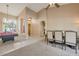 Spacious living room with pool table, dining area, and ample natural light at 10907 E Bella Vista Dr, Scottsdale, AZ 85259