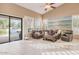 Bright living room featuring a large mural, comfortable seating, and access to the backyard at 10907 E Bella Vista Dr, Scottsdale, AZ 85259