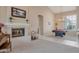 Elegant living room with fireplace and mantel and a pool table by bright shuttered windows at 10907 E Bella Vista Dr, Scottsdale, AZ 85259