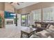 Relaxing living room with fireplace and an entertainment center, opening to patio at 10907 E Bella Vista Dr, Scottsdale, AZ 85259