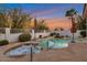 Backyard pool with spa, waterfall feature, landscaping, and an orange sunset sky at 10907 E Bella Vista Dr, Scottsdale, AZ 85259