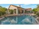 Inviting backyard featuring a sparkling pool, covered patio, and desert landscaping at 10907 E Bella Vista Dr, Scottsdale, AZ 85259