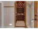 View of an ample wine cellar with custom wood racking and tile floor at 10907 E Bella Vista Dr, Scottsdale, AZ 85259
