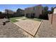 Backyard with paved patio, artificial turf, and low-maintenance landscaping at 11460 W Eden Mckenzie Dr, Surprise, AZ 85378