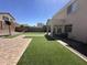 Clean backyard with a patio, artificial turf, and nice hardscape at 11460 W Eden Mckenzie Dr, Surprise, AZ 85378