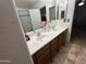 Bathroom with a double sink vanity, large mirror, and tiled floor at 11460 W Eden Mckenzie Dr, Surprise, AZ 85378