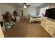 Standard bedroom featuring a ceiling fan, closet, dresser and window with blinds at 11460 W Eden Mckenzie Dr, Surprise, AZ 85378