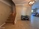A light and airy foyer featuring tile floors and staircase leading to the second floor at 11460 W Eden Mckenzie Dr, Surprise, AZ 85378