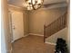 A light and airy foyer featuring tile floors and staircase leading to the second floor at 11460 W Eden Mckenzie Dr, Surprise, AZ 85378