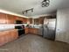 Traditional kitchen with stainless steel appliances, wooden cabinets, and ample countertop space at 11460 W Eden Mckenzie Dr, Surprise, AZ 85378