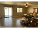 Bright living room featuring tile floors, sliding glass doors to the patio, and natural light at 11460 W Eden Mckenzie Dr, Surprise, AZ 85378