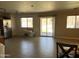 Open-concept living room with tile flooring, natural light, and sliding glass door to backyard at 11460 W Eden Mckenzie Dr, Surprise, AZ 85378