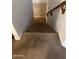 Staircase with neutral carpet and a wood handrail leading to the upper level at 11460 W Eden Mckenzie Dr, Surprise, AZ 85378