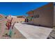 The backyard features decorative, desert-style landscaping and is surrounded by a block fence for added privacy at 14141 E Highland Ave, Fountain Hills, AZ 85268