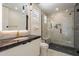 Modern bathroom with glass shower, black marble countertop, sleek cabinets, and pendant lighting at 14141 E Highland Ave, Fountain Hills, AZ 85268