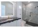 Modern bathroom with glass shower, black marble countertop, sleek cabinets, and pendant lighting at 14141 E Highland Ave, Fountain Hills, AZ 85268