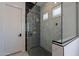 Modern bathroom featuring a glass enclosed shower, white marble tiling, and bronze fixtures at 14141 E Highland Ave, Fountain Hills, AZ 85268