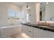 Luxurious bathroom with double vanity, marble countertops, soaking tub, and elegant fixtures at 14141 E Highland Ave, Fountain Hills, AZ 85268