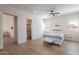 Bright bedroom features light hardwood floors, window shutters, ceiling fan, and cozy decor at 14141 E Highland Ave, Fountain Hills, AZ 85268