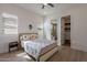 Bright bedroom features light hardwood floors, window shutters, ceiling fan, and cozy decor at 14141 E Highland Ave, Fountain Hills, AZ 85268