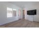 Bright bedroom with hardwood floors, window shutters, ceiling fan, and minimalist decor at 14141 E Highland Ave, Fountain Hills, AZ 85268