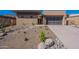 Contemporary home featuring desert landscaping with a concrete driveway and a full glass garage door at 14141 E Highland Ave, Fountain Hills, AZ 85268