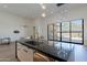 Kitchen island showcases black marble countertop, stainless steel sink, and modern pendant lighting at 14141 E Highland Ave, Fountain Hills, AZ 85268