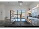 Kitchen island with black marble countertop and stainless steel sink faces sliding glass doors and mountain views at 14141 E Highland Ave, Fountain Hills, AZ 85268