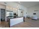 Bright, modern kitchen with black marble island and countertops, wood floors, stainless steel appliances, and pendant lighting at 14141 E Highland Ave, Fountain Hills, AZ 85268