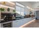 Open kitchen featuring black marble countertops and backsplash, stainless steel appliances, and bright, modern lighting at 14141 E Highland Ave, Fountain Hills, AZ 85268