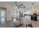 Bright living room with wood floors features modern lighting, comfortable seating, and an open connection to the kitchen at 14141 E Highland Ave, Fountain Hills, AZ 85268